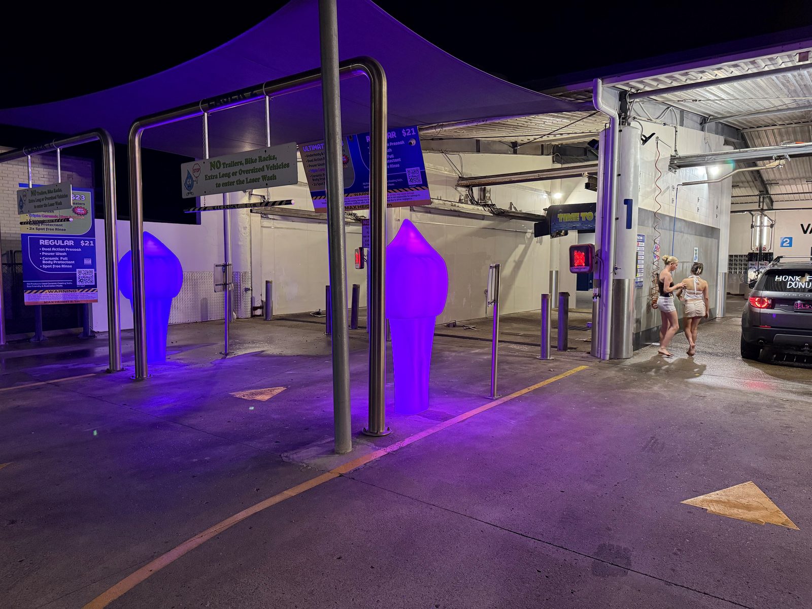 Purple-lit auto entry under the site canopy