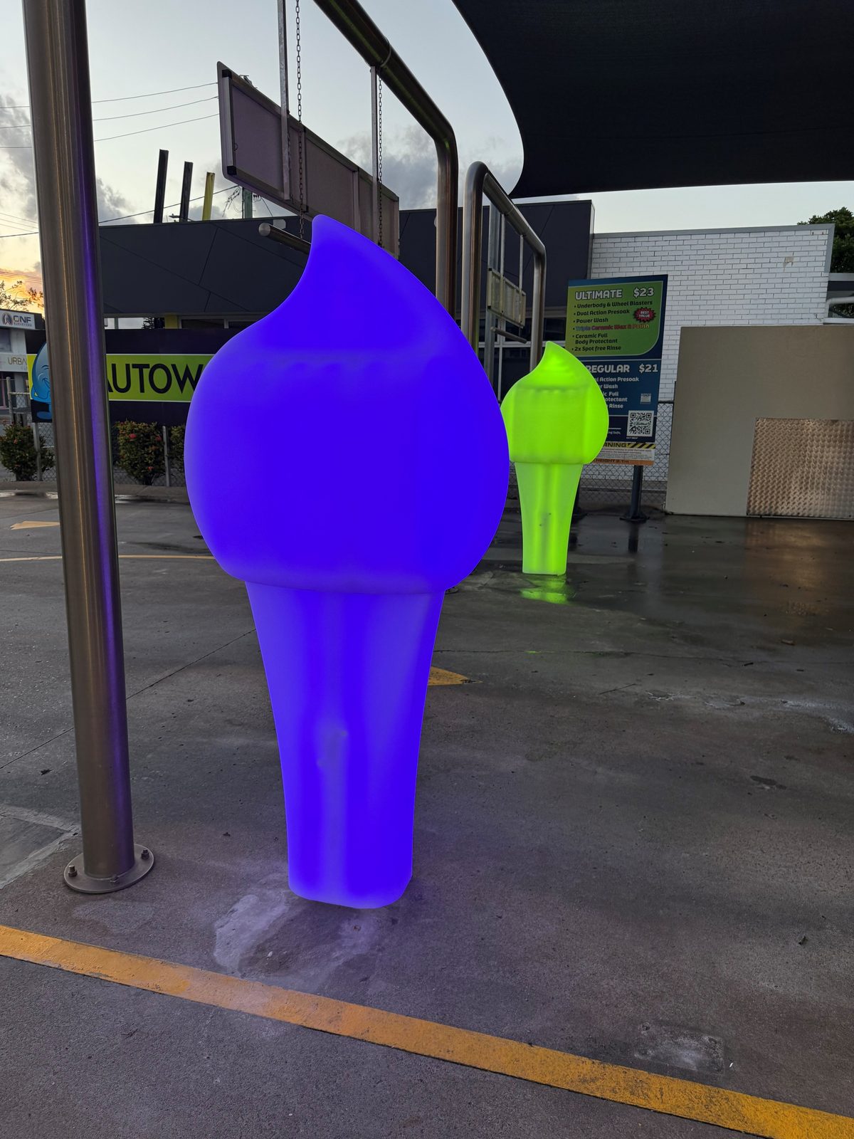 Blue and green Paydrop plinths at an autowash