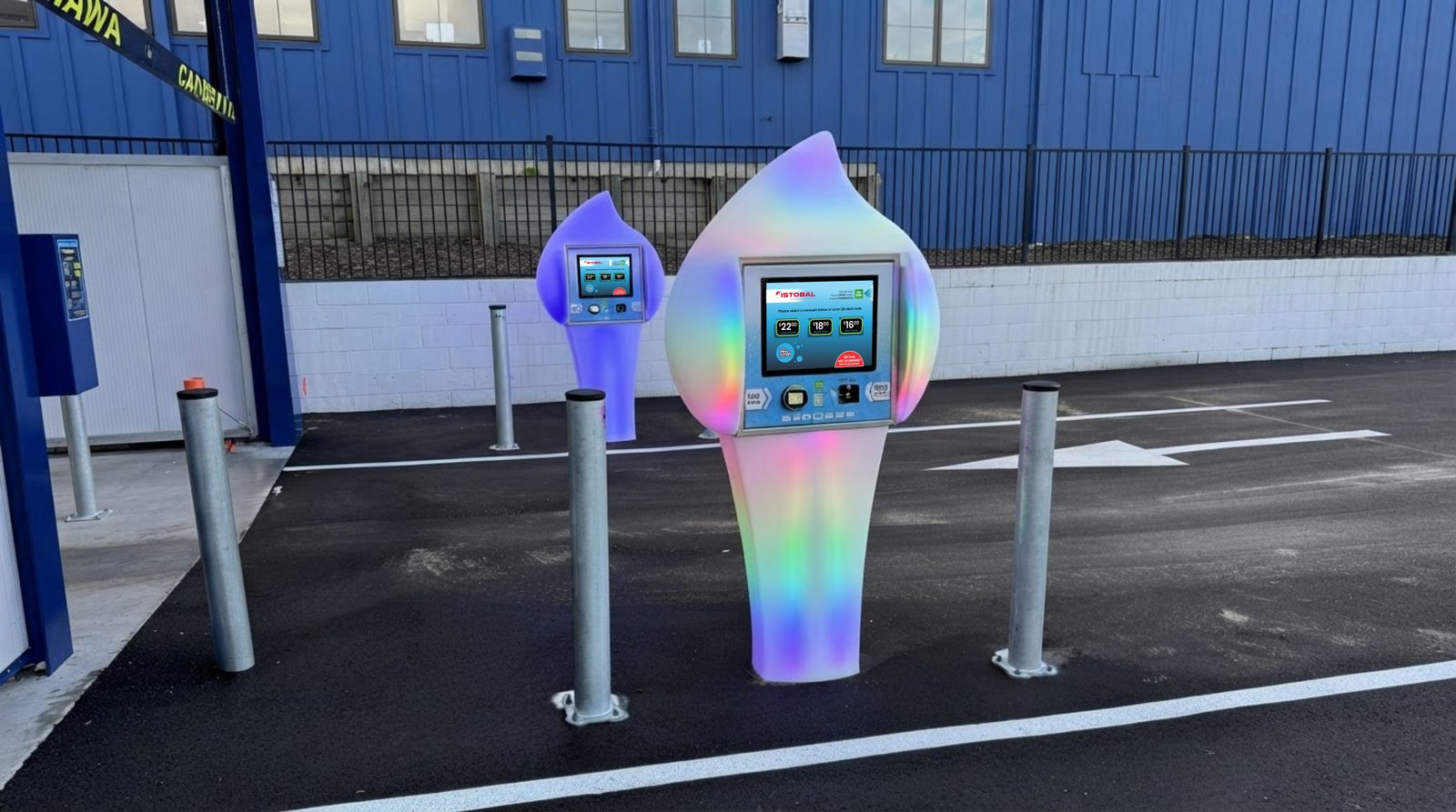 Two Paydrop LED auto-entry plinths glowing in rainbow colours at a wash entry