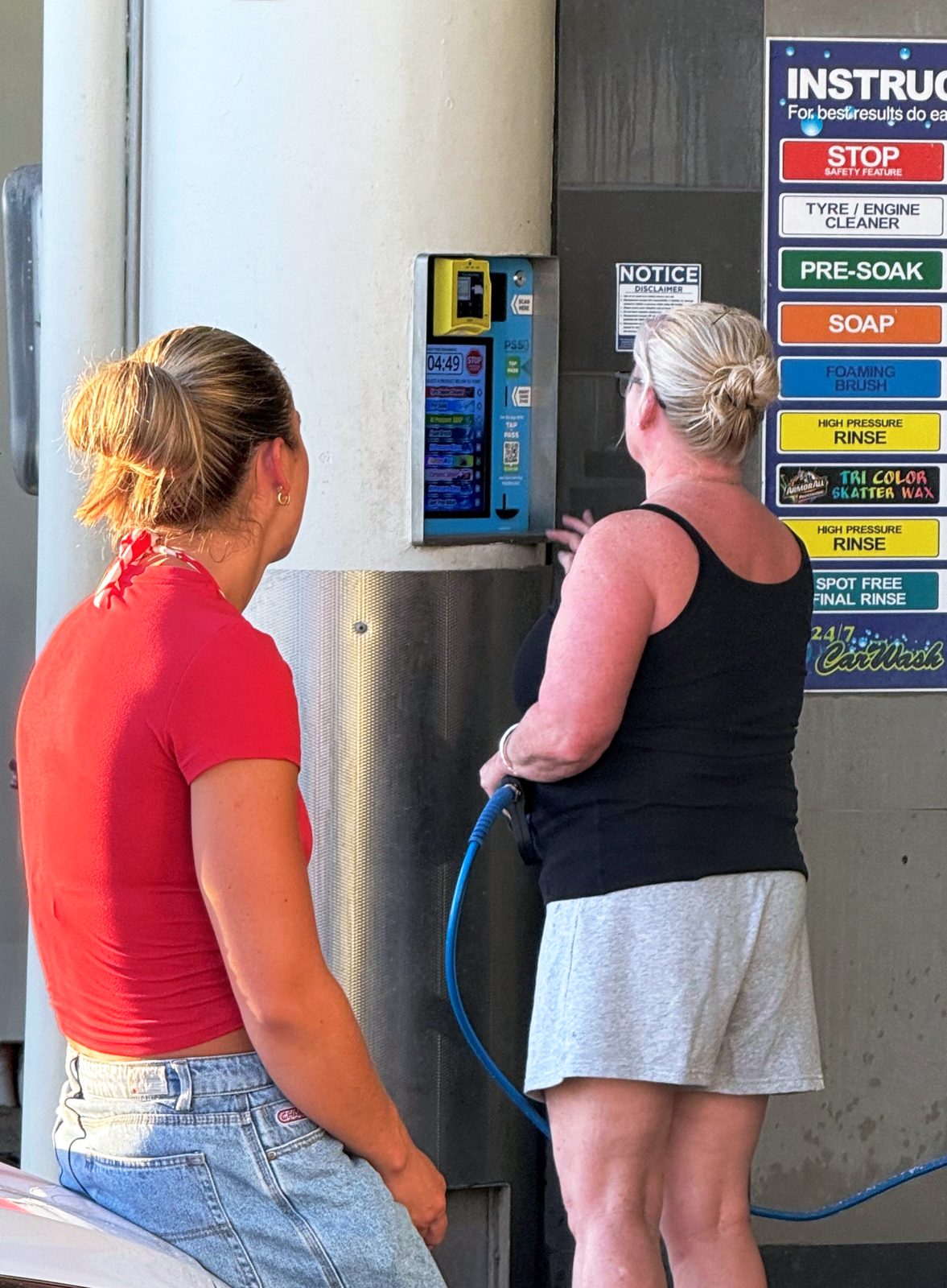 A customer washing with the retrofitted self-serve unit